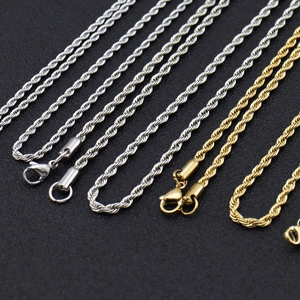 Detailed macro view of gold and silver 3mm stainless steel rope chains with lobster clasps