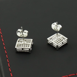 Detail view of square zircon stud earrings showing silver hollow back and butterfly clasps