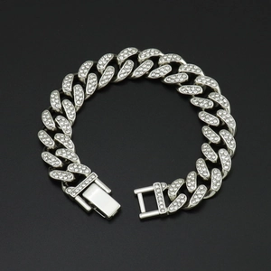 Macro detail of silver Cuban chain with shimmering rhinestones and secure square clasp