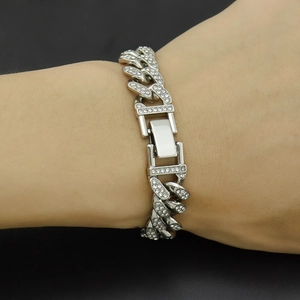 Close-up detail of silver iced-out 12mm Cuban link chain with paved rhinestones