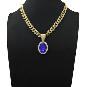 Macro shot of Cuban chain necklace with oval blue gemstone and shimmering micro-pave diamonds
