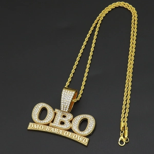 Detailed view of gold plated OBO hip hop pendant necklace with iced out zircon pavé