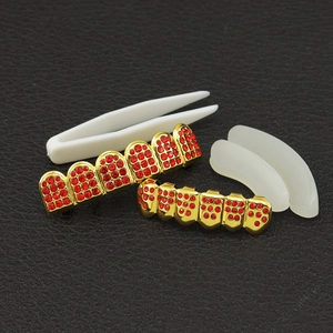 Hip-hop gold-plated teeth grillz set with red rhinestones, tweezers, and silicone bars