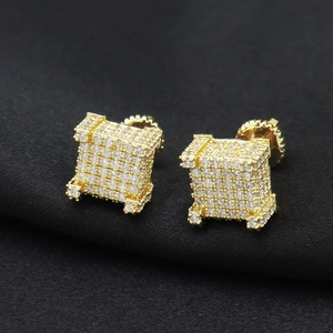 Macro shot of hip-hop square cube earrings with gold plating and pavé cubic zirconia
