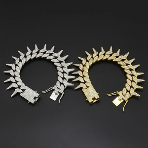 Detailed close-up of hip-hop iced out Cuban bracelets with spikes in gold and silver