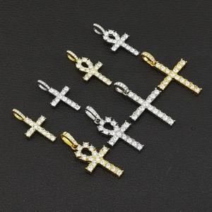 Hip-Hop gold and silver iced-out cross and Egyptian Ankh pendants on black background