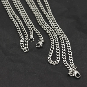 Sleek silver stainless steel 3mm Cuban link chains with lobster clasps on black surface