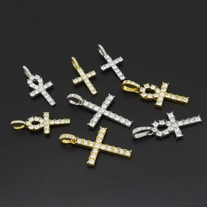 Detail shot of gold and silver Ankh cross pendants with sparkling iced out rhinestones