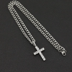 Detailed view of silver hip hop cross pendant with sparkling rhinestones and cuban chain