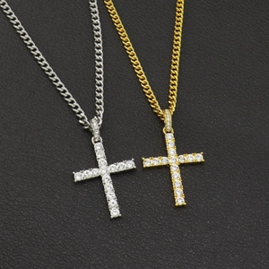 Detail showing gold and silver hip hop cross pendants with cuban chains on leather