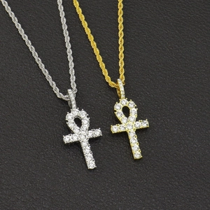 Detailed view of gold and silver Ankh cross pendants with sparkling rhinestones for men