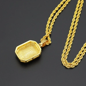 Close-up of golden square pendant back with textured finish and twisted rope chain
