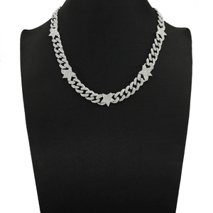 Macro view of silver hiphop cuban chain necklace with iced out pentagram stars