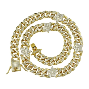 Gold hip hop Cuban link necklace featuring iced out five pointed star charms and rhinestones