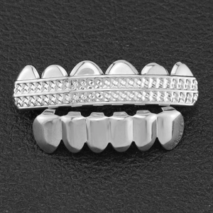 Macro shot of silver hiphop grillz set showing intricate diamond grid patterns on black leather
