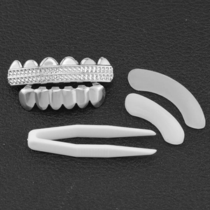 Silver hip hop teeth grillz set with checkered texture including silicone bars and tweezers