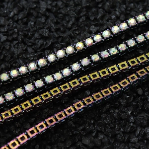 Macro detail of rainbow tennis chains featuring colorful zircon stones and dark metal links