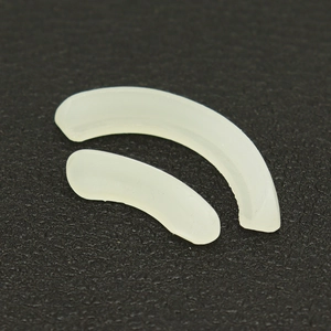 Close-up of off-white silicone mold for hip hop dental grillz on black leather