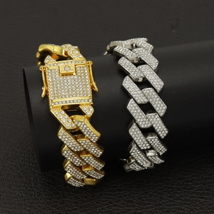 Detail view of 20mm iced out Cuban link bracelets in gold and silver with full rhinestones