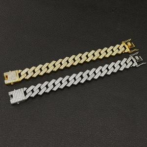 Close-up of 20mm iced out Cuban link chains in gold and silver with triple row crystals