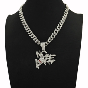 Detailed macro view of the full diamond iced-out NO LOVE heart pendant necklace