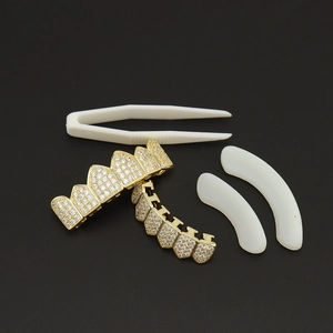 Hip hop gold teeth grillz set with cubic zirconia stones including tweezers and silicone strips