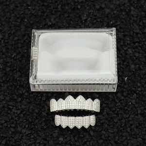 Macro view of silver hip hop grillz set with cubic zirconia stones in storage case