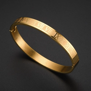 Golden stainless steel bangle with engraved Roman numerals and hinged opening mechanism