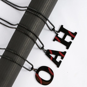 Detailed close-up of titanium steel baseball letter pendants with red stitch details