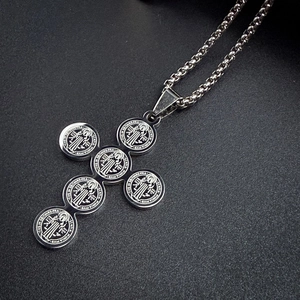 Detailed view of silver St. Benedict medal cross pendant with stainless steel chain