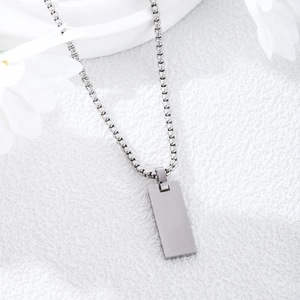 Minimalist stainless steel rectangle pendant necklace with matte silver finish on white background