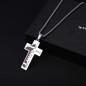 Polished stainless steel cross pendant necklace with PH4:13 verse on a black jewelry box