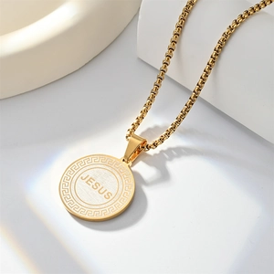 Golden Jesus pendant necklace with Greek key pattern and box chain on white display