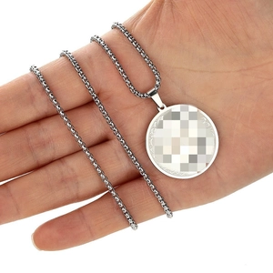 Vintage stainless steel round pendant necklace with box chain held by hand