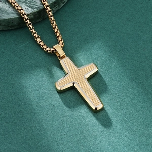 Two-tone stainless steel cross pendant with gold box chain and textured silver inlay