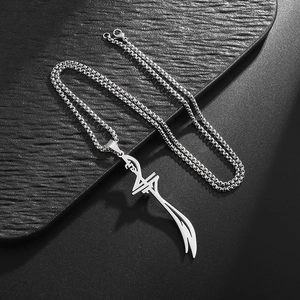 Detail view of silver Zulfiqar sword pendant on box chain over black leather