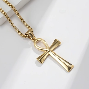 Golden stainless steel Ankh cross necklace with round box chain on white geometric steps