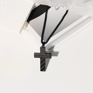 Detail of black stainless steel cross necklace engraved with 'BEST BRO EVER' text