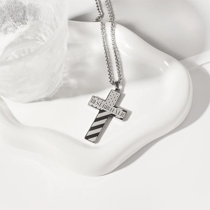 Detail of silver stainless steel cross pendant with Best Bro Ever engraving and stars