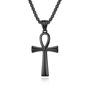 Macro detail of matte black stainless steel Ankh cross pendant on a box chain link