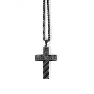 Macro detail of black stainless steel cross necklace with stars and stripes engraving