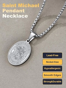 Macro shot of Saint Michael relief carving on oval stainless steel shield pendant