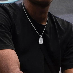 Archangel Saint Michael stainless steel necklace worn on a black shirt by a male model