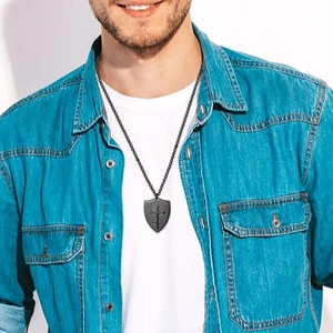 Men's matte black shield cross pendant with round bead chain on a male model