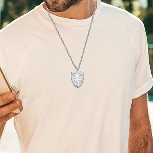 Men's stainless steel shield cross necklace with Bible verse engraving on model