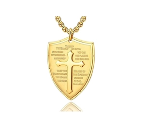 Detailed close-up of gold shield pendant with cross relief and Bible verse engraving