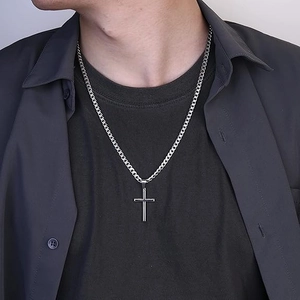 Minimalist silver stainless steel cross pendant necklace with curb chain on male model