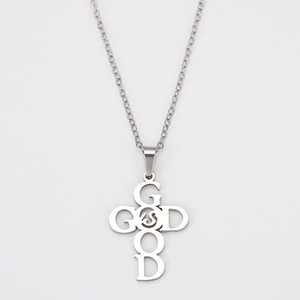 Detail of silver stainless steel cross pendant featuring GOOD and GOD letter engraving