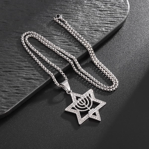 Star of David necklace with crystal inlay and Menorah symbol on textured background