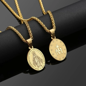 Macro view of double-sided gold stainless steel religious medallion with cross detail